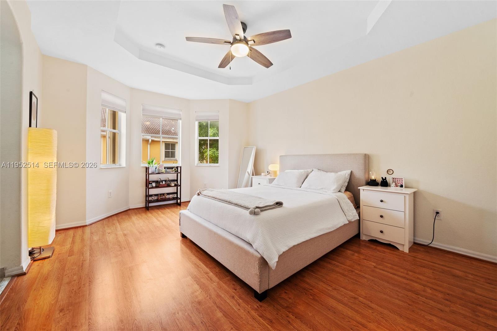 16634 Southwest 79th Terrace Miami, FL 33193 - Photo 13 of 25 a bedroom with a bed and a chandelier fan