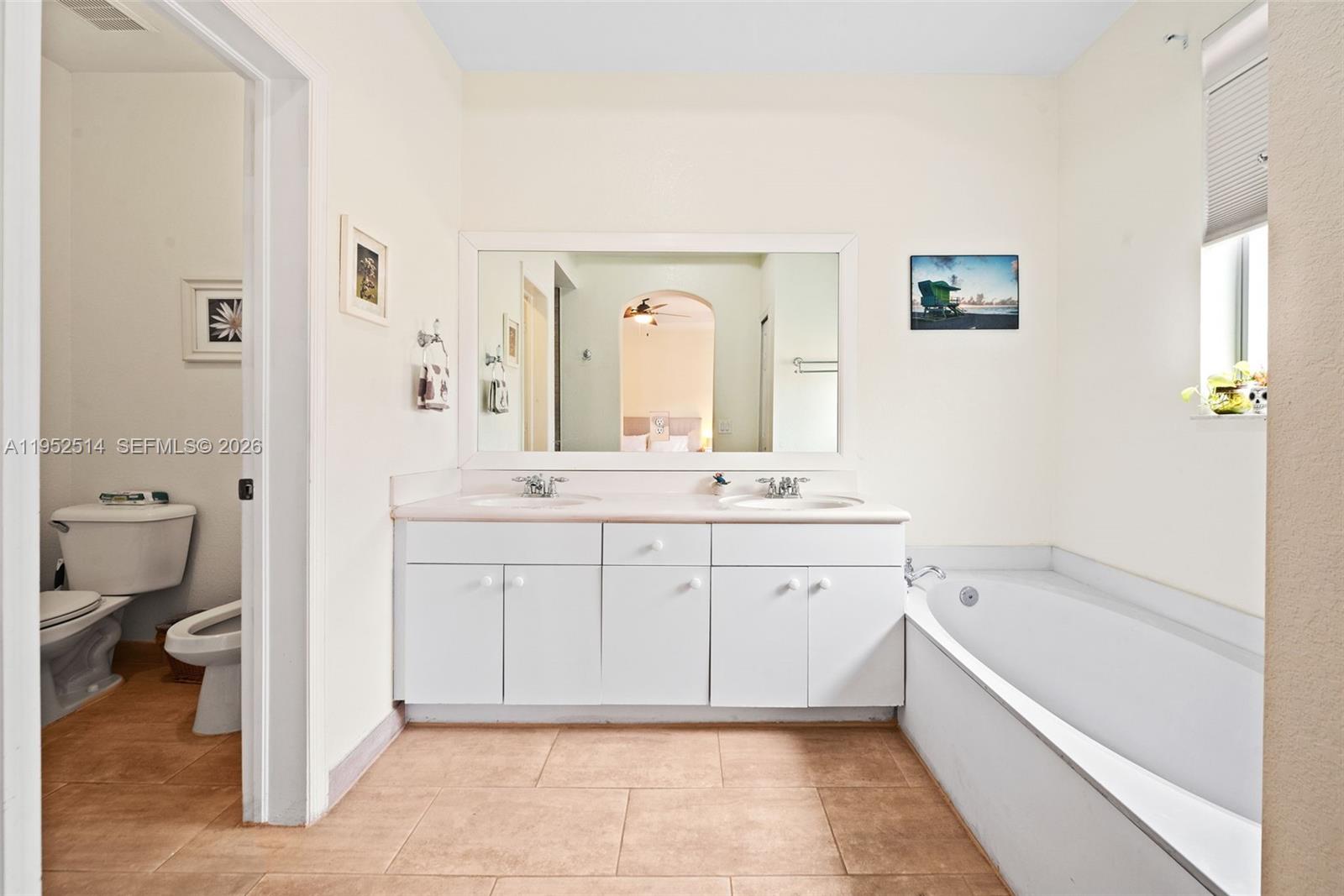 16634 Southwest 79th Terrace Miami, FL 33193 - Photo 15 of 25 a spacious bathroom with a granite countertop sink mirror and toilet