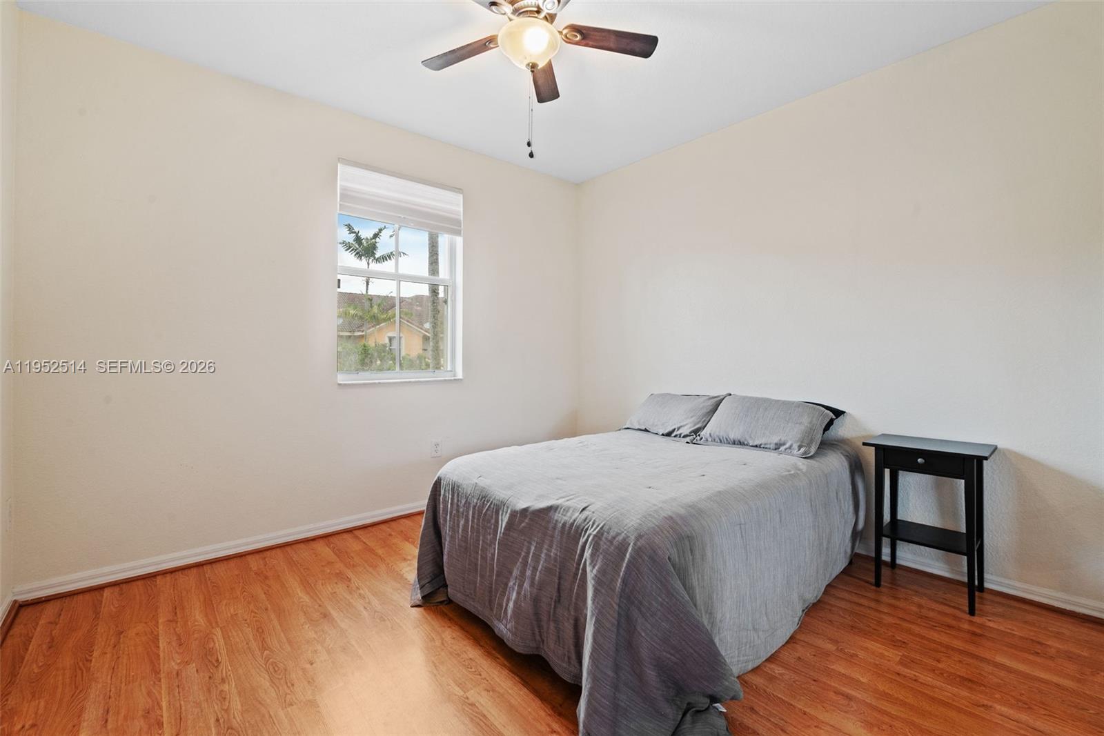 16634 Southwest 79th Terrace Miami, FL 33193 - Photo 18 of 25 a bedroom with a bed and a chandelier