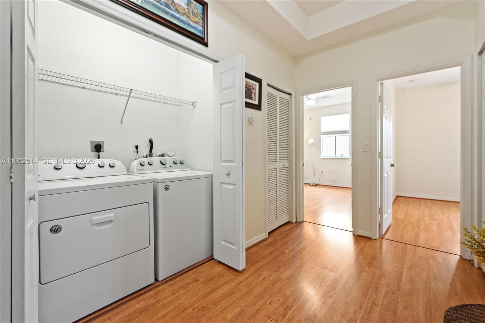 16634 Southwest 79th Terrace Miami, FL 33193 - Photo 21 of 25 a utility room with cabinets washer and dryer