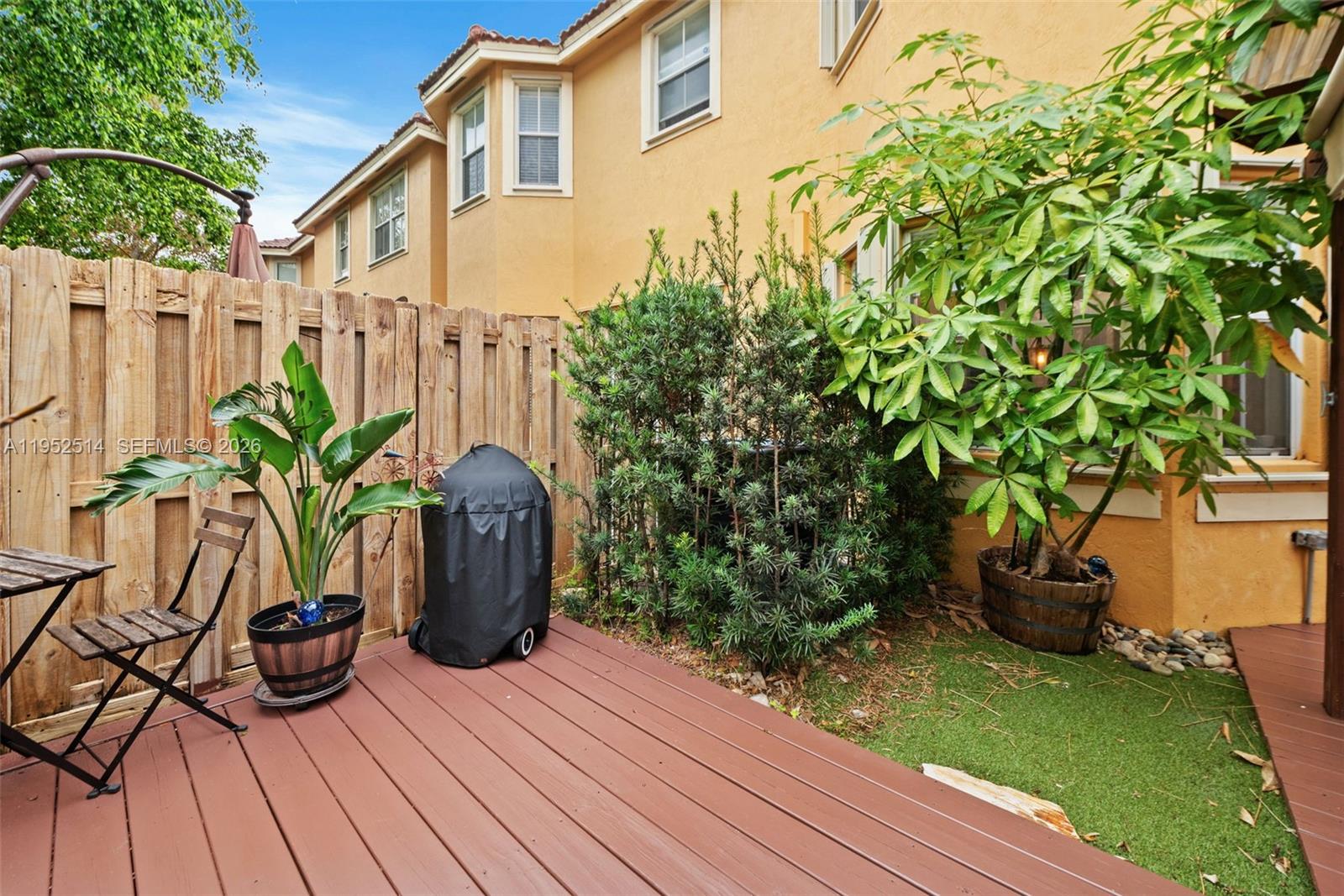16634 Southwest 79th Terrace Miami, FL 33193 - Photo 25 of 25 a view of a potted flower in a yard next to a house