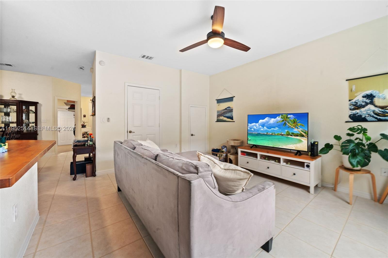 16634 Southwest 79th Terrace Miami, FL 33193 - Photo 7 of 25 a living room with furniture and a flat screen tv