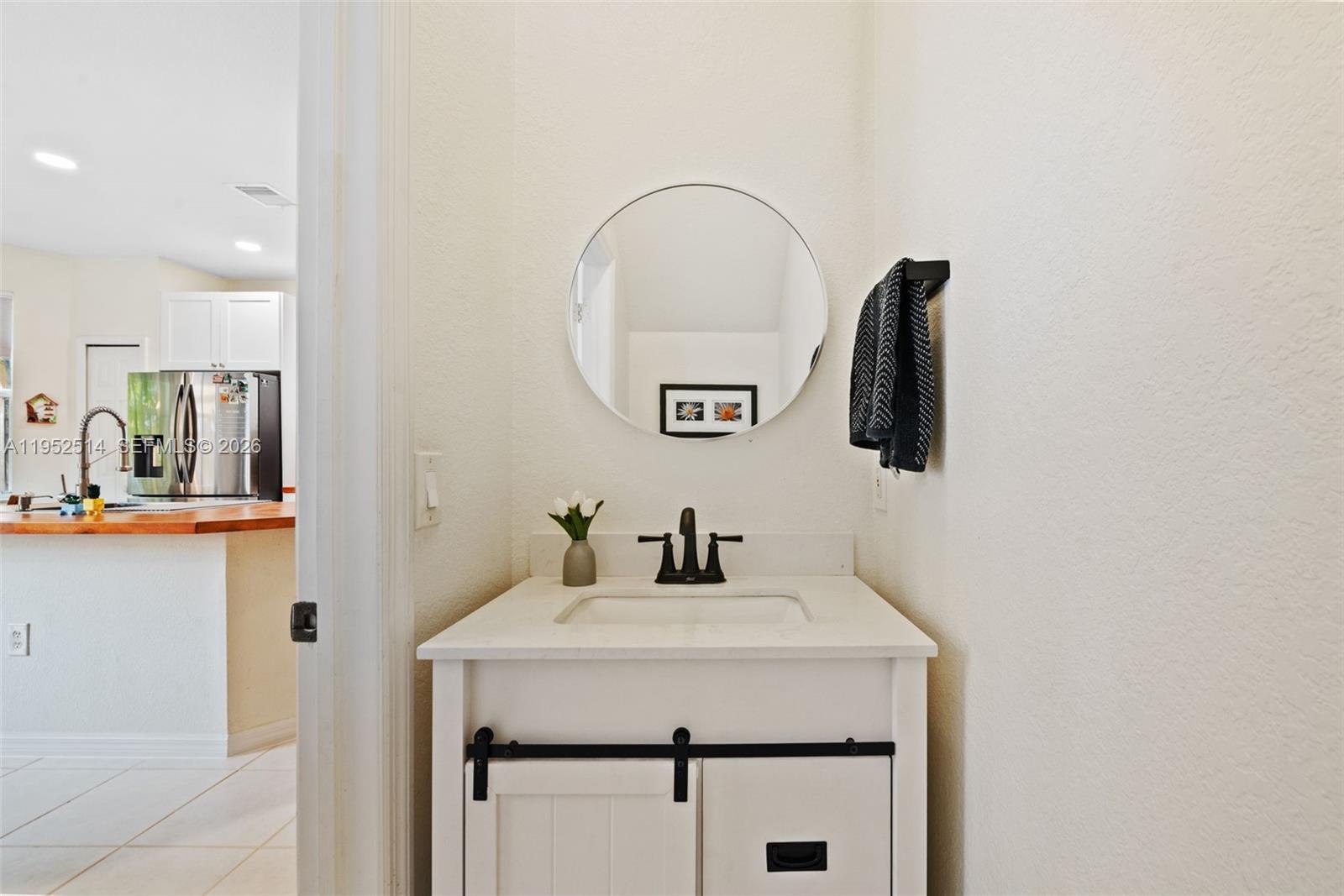 16634 Southwest 79th Terrace Miami, FL 33193 - Photo 9 of 25 a bathroom with a sink and a mirror