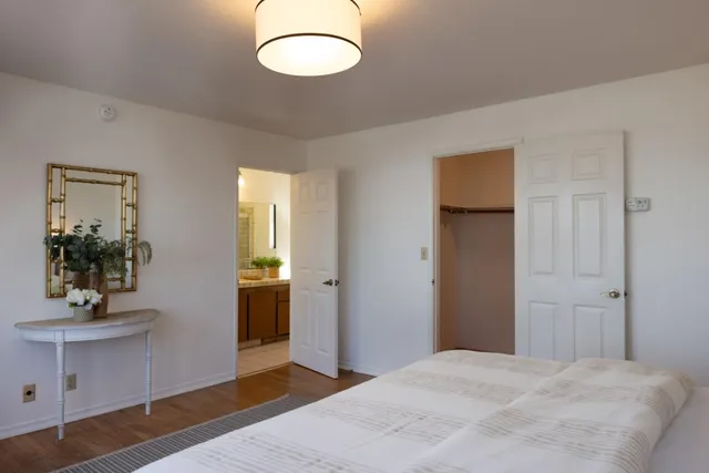 a bedroom with a bed and a mirror