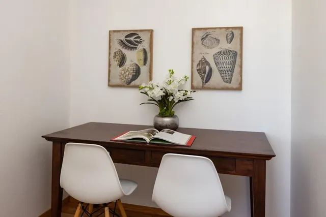 a view of a workspace with a table and a chair