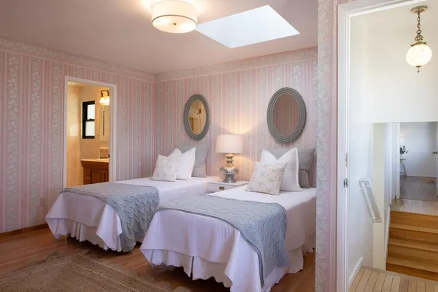 a bedroom with a bed and a painting on the wall