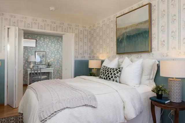 a bedroom with a bed and a mirror