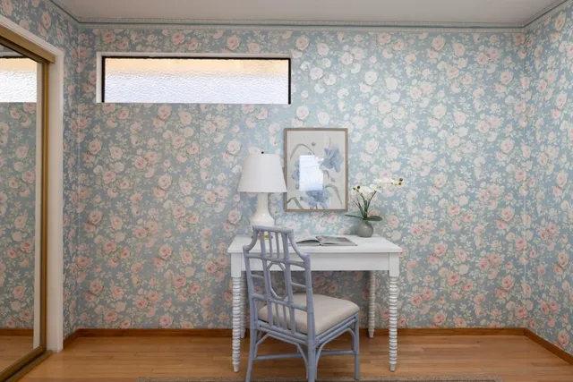 a dining room with a wooden table and chairs
