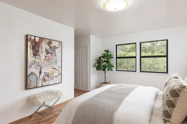 a bedroom with a bed and a window