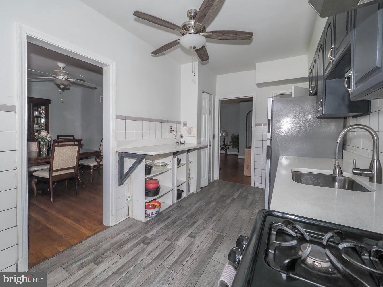 1540 Lochwood Road Baltimore, MD 21218 - Photo 13 of 46 a kitchen with stainless steel appliances granite countertop a sink stove and cabinets