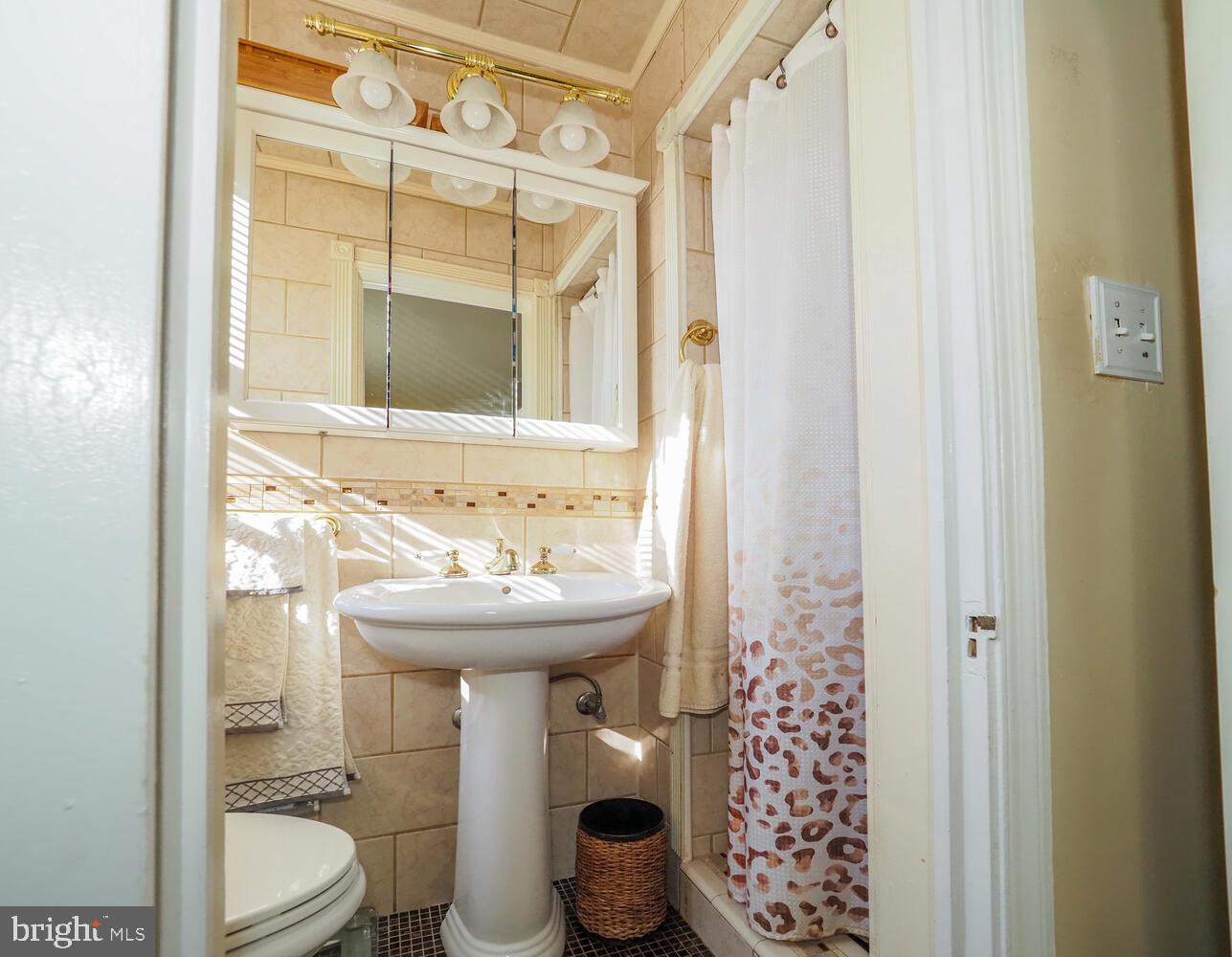 1540 Lochwood Road Baltimore, MD 21218 - Photo 20 of 46 a bathroom with a sink and a mirror