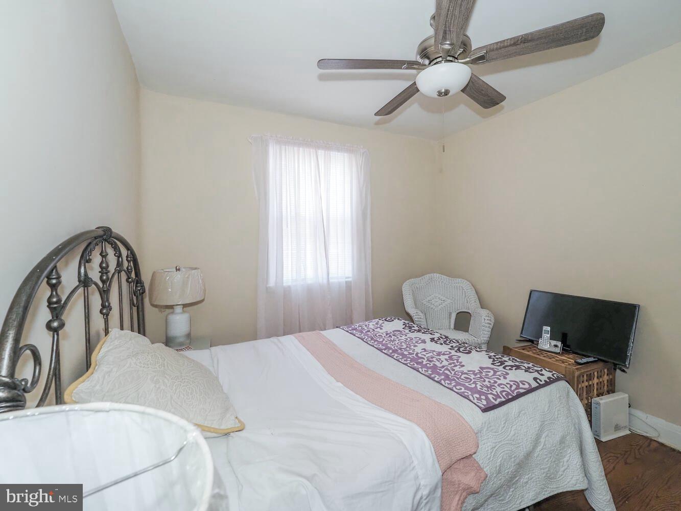 1540 Lochwood Road Baltimore, MD 21218 - Photo 22 of 46 a bedroom with a large bed and a chandelier