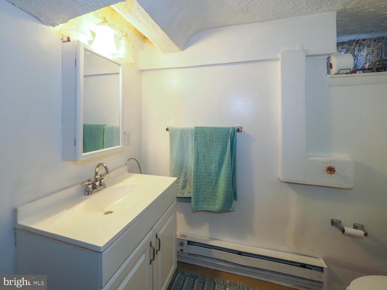 1540 Lochwood Road Baltimore, MD 21218 - Photo 33 of 46 a bathroom with a sink and mirror