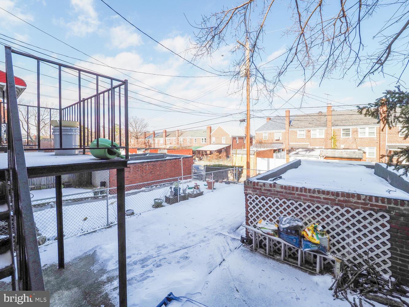 1540 Lochwood Road Baltimore, MD 21218 - Photo 39 of 46 a view of a patio with a table chairs and wooden fence