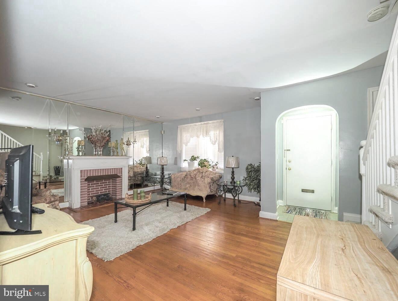 1540 Lochwood Road Baltimore, MD 21218 - Photo 5 of 46 a living room with furniture fireplace and a table