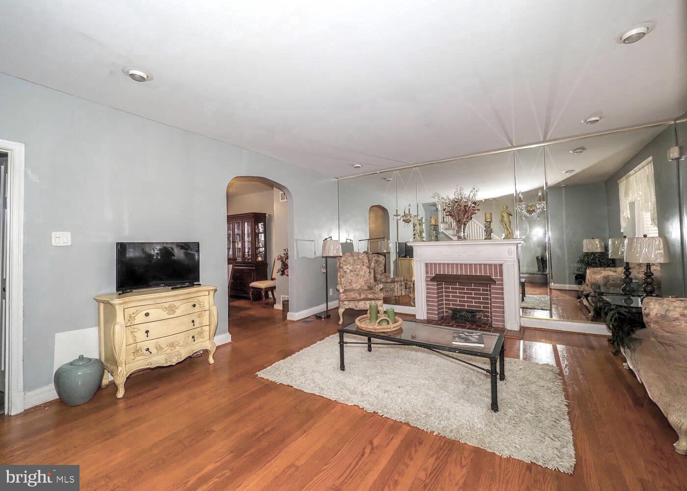 1540 Lochwood Road Baltimore, MD 21218 - Photo 7 of 46 a living room with furniture and a flat screen tv