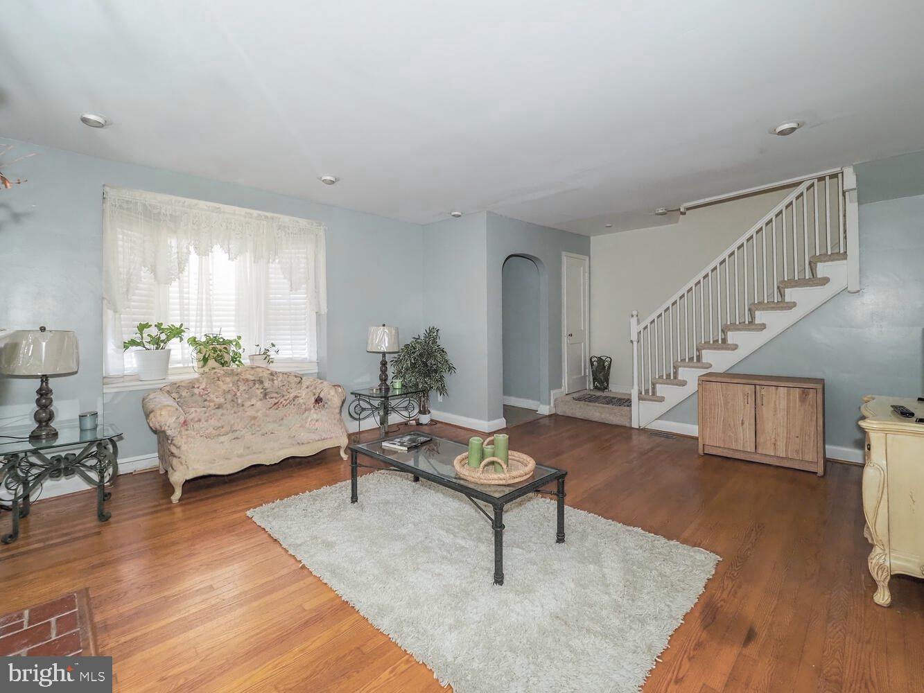1540 Lochwood Road Baltimore, MD 21218 - Photo 8 of 46 a living room with furniture and wooden floor