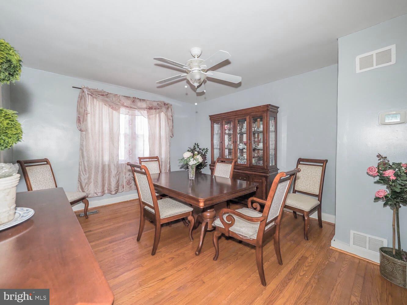 1540 Lochwood Road Baltimore, MD 21218 - Photo 9 of 46 a view of a dining room with furniture and wooden floor