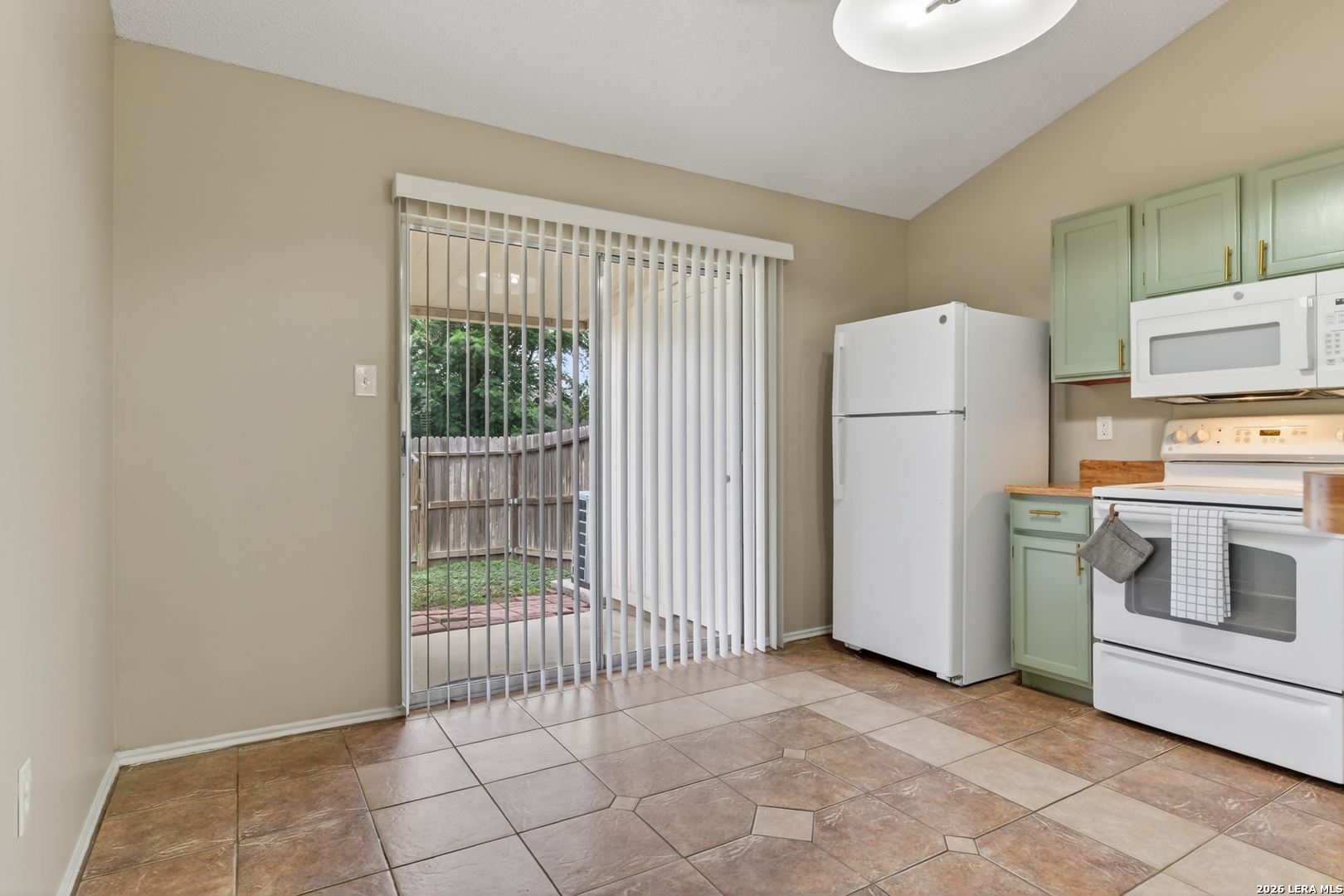 10254 Dover Ridge, Unit 806 San Antonio, TX 78250 - Photo 11 of 16 a view of a kitchen with refrigerator and microwave