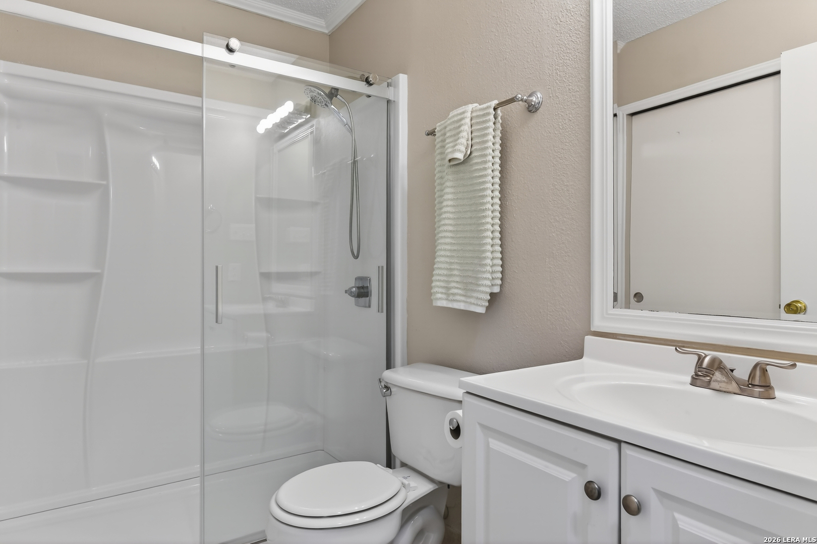 10254 Dover Ridge, Unit 806 San Antonio, TX 78250 - Photo 13 of 16 a bathroom with a sink a toilet and shower