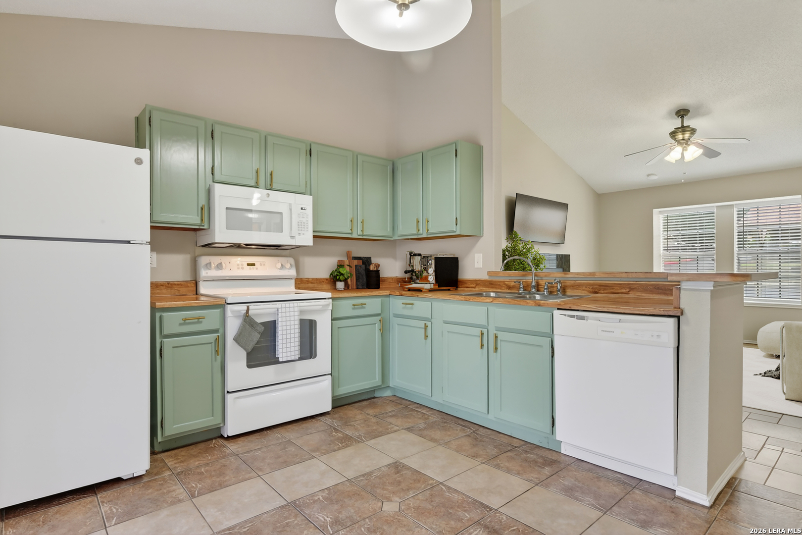 10254 Dover Ridge, Unit 806 San Antonio, TX 78250 - Photo 3 of 16 a kitchen with a refrigerator and a stove top oven