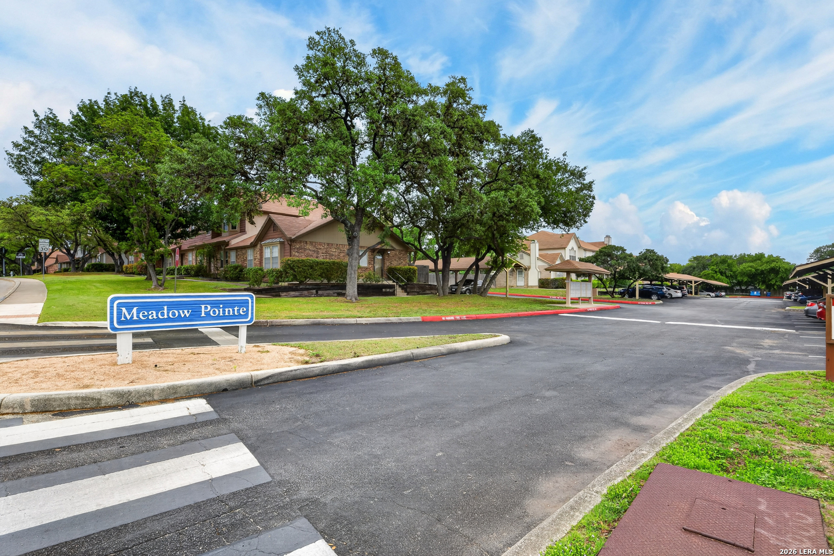 10254 Dover Ridge, Unit 806 San Antonio, TX 78250 - Photo 6 of 16 a view of a park with large trees