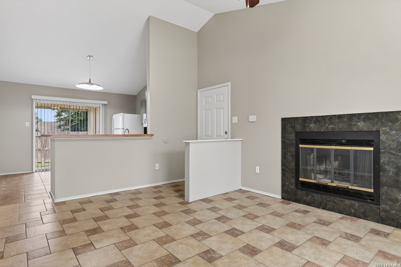 10254 Dover Ridge, Unit 806 San Antonio, TX 78250 - Photo 8 of 16 a view of empty room with wooden floor and fireplace