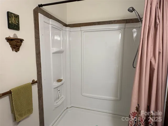 a bathroom with a shower and a sink