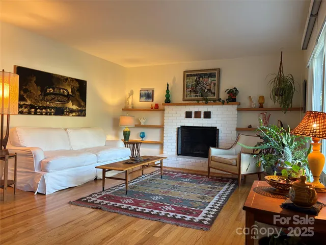 a living room with furniture a rug and a fireplace