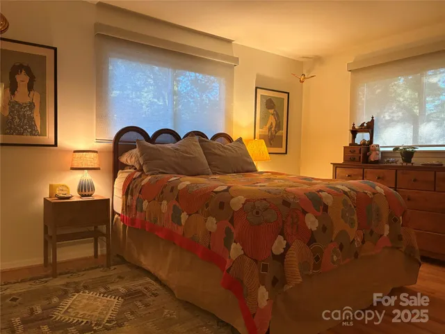 a large bed sitting in a bedroom next to a window