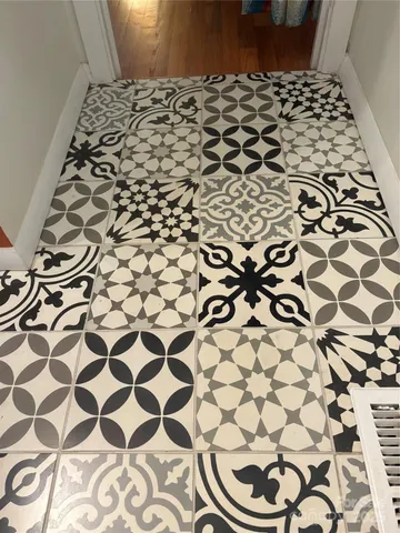 a bathroom with a black white checkered floor
