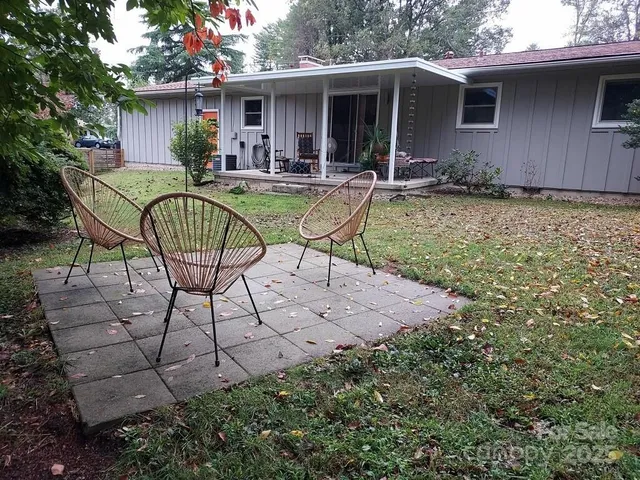 a view of house with backyard outdoor seating and patio