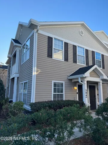 a front view of a house with plants