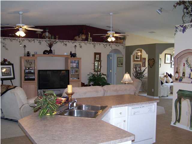 2549 Crescent Road Navarre, FL 32566 - Photo 11 of 22 a living room with fireplace furniture and a flat screen tv