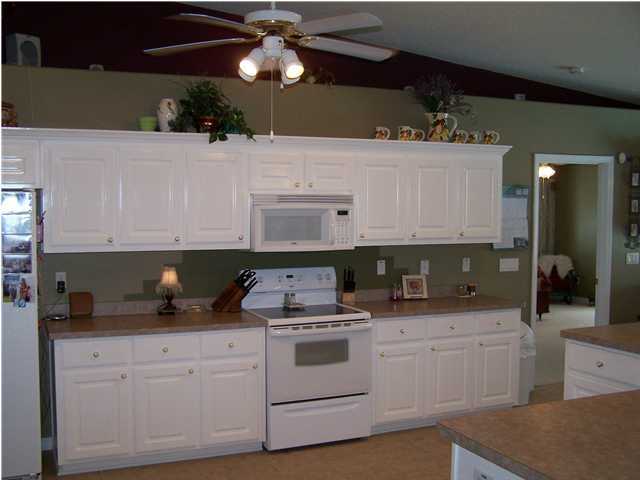 2549 Crescent Road Navarre, FL 32566 - Photo 13 of 22 a kitchen with cabinets appliances and a counter top