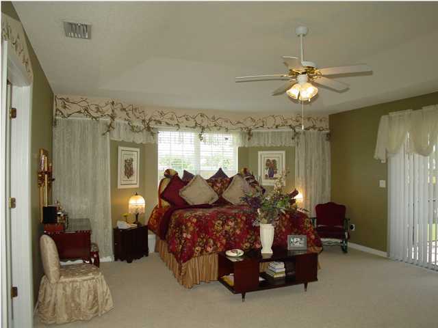 2549 Crescent Road Navarre, FL 32566 - Photo 14 of 22 a bed room with furniture and a chandelier