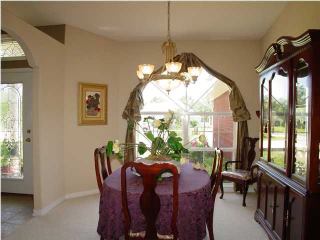 2549 Crescent Road Navarre, FL 32566 - Photo 15 of 22 a view of a dining room with furniture window and outside view
