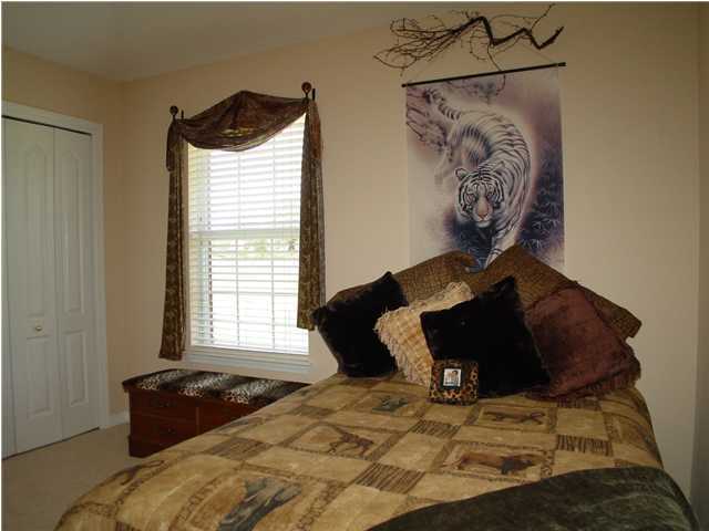 2549 Crescent Road Navarre, FL 32566 - Photo 17 of 22 a bedroom with a bed and a window