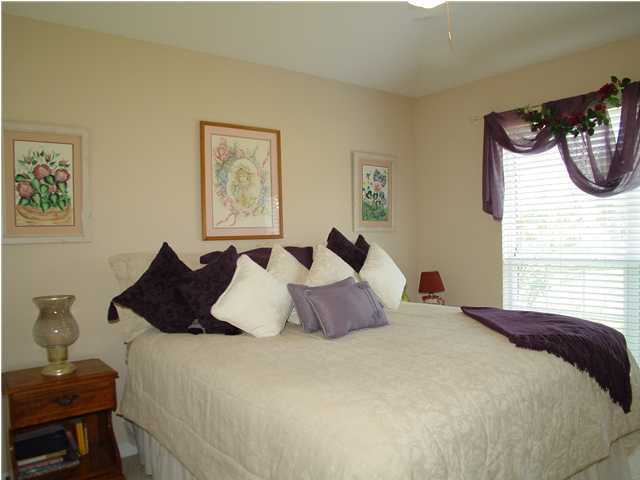 2549 Crescent Road Navarre, FL 32566 - Photo 19 of 22 a bedroom with a bed and wooden floor