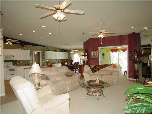 2549 Crescent Road Navarre, FL 32566 - Photo 7 of 22 a living room with furniture kitchen view and a chandelier