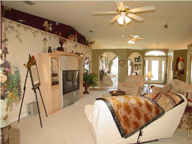 2549 Crescent Road Navarre, FL 32566 - Photo 9 of 22 a living room with furniture and a flat screen tv