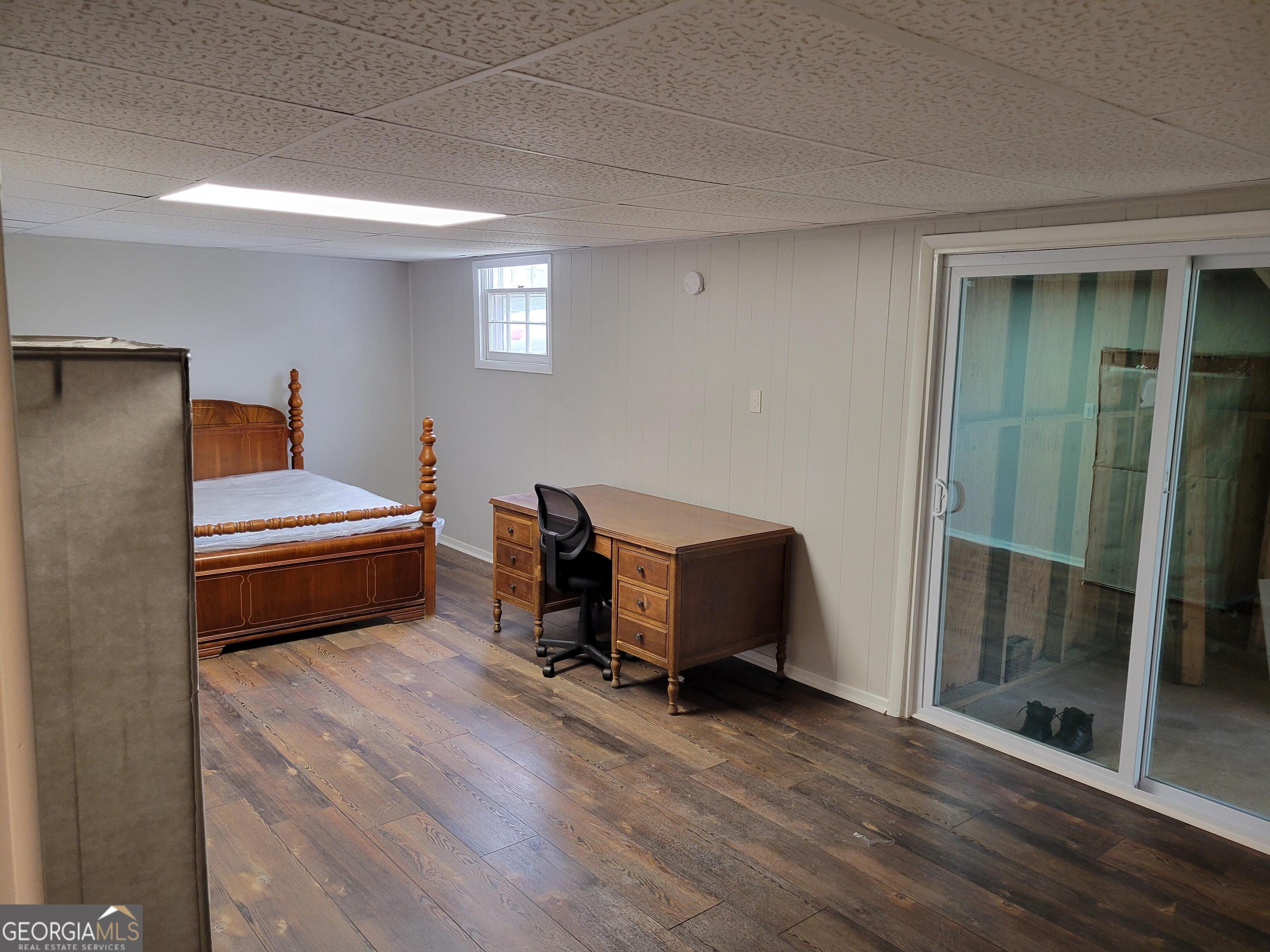 6057 Pinecreek Road Forest Park, GA 30297 - Photo 11 of 15 a bedroom with a bed and wooden floor