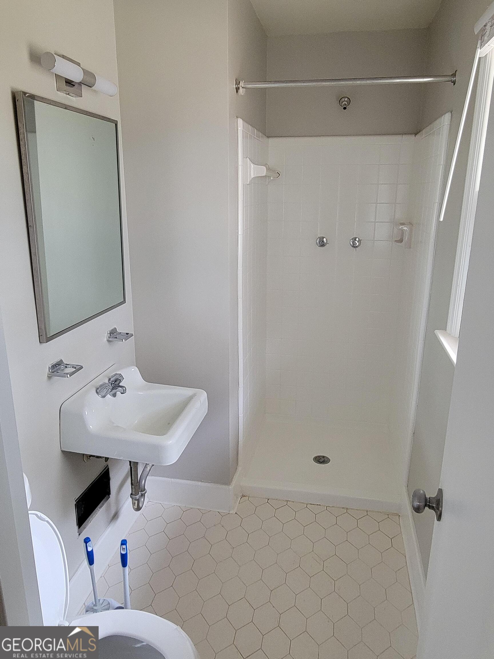 6057 Pinecreek Road Forest Park, GA 30297 - Photo 14 of 15 a bathroom with a sink a toilet and shower