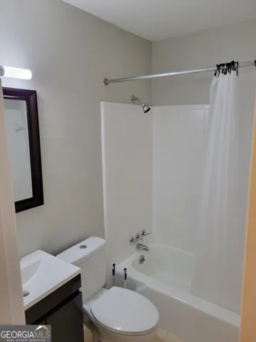 a bathroom with a toilet a sink and bathtub