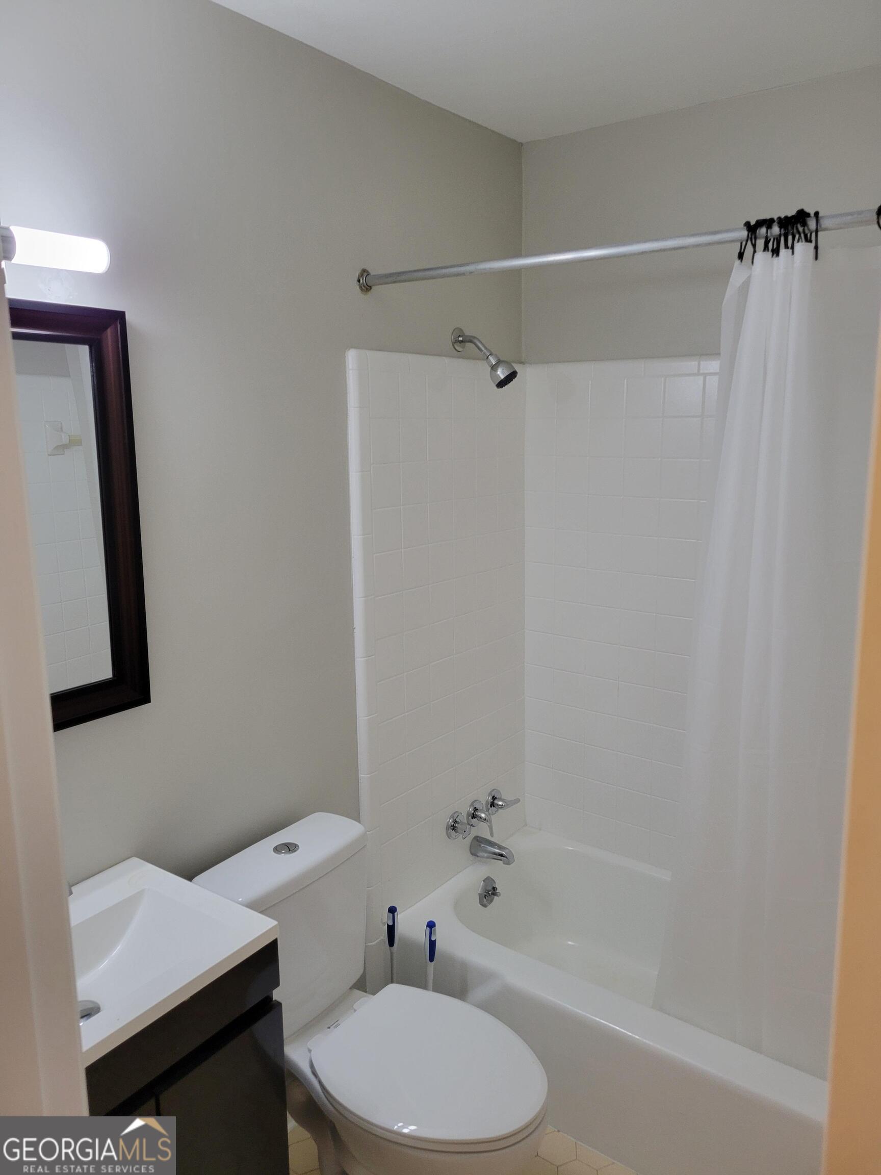 6057 Pinecreek Road Forest Park, GA 30297 - Photo 15 of 15 a bathroom with a toilet a sink and bathtub