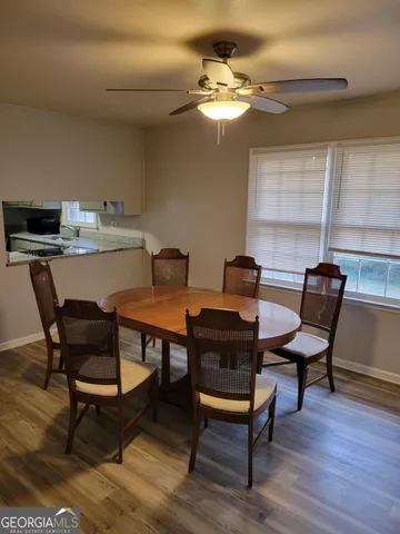 a view of a dining room with furniture and wooden floor