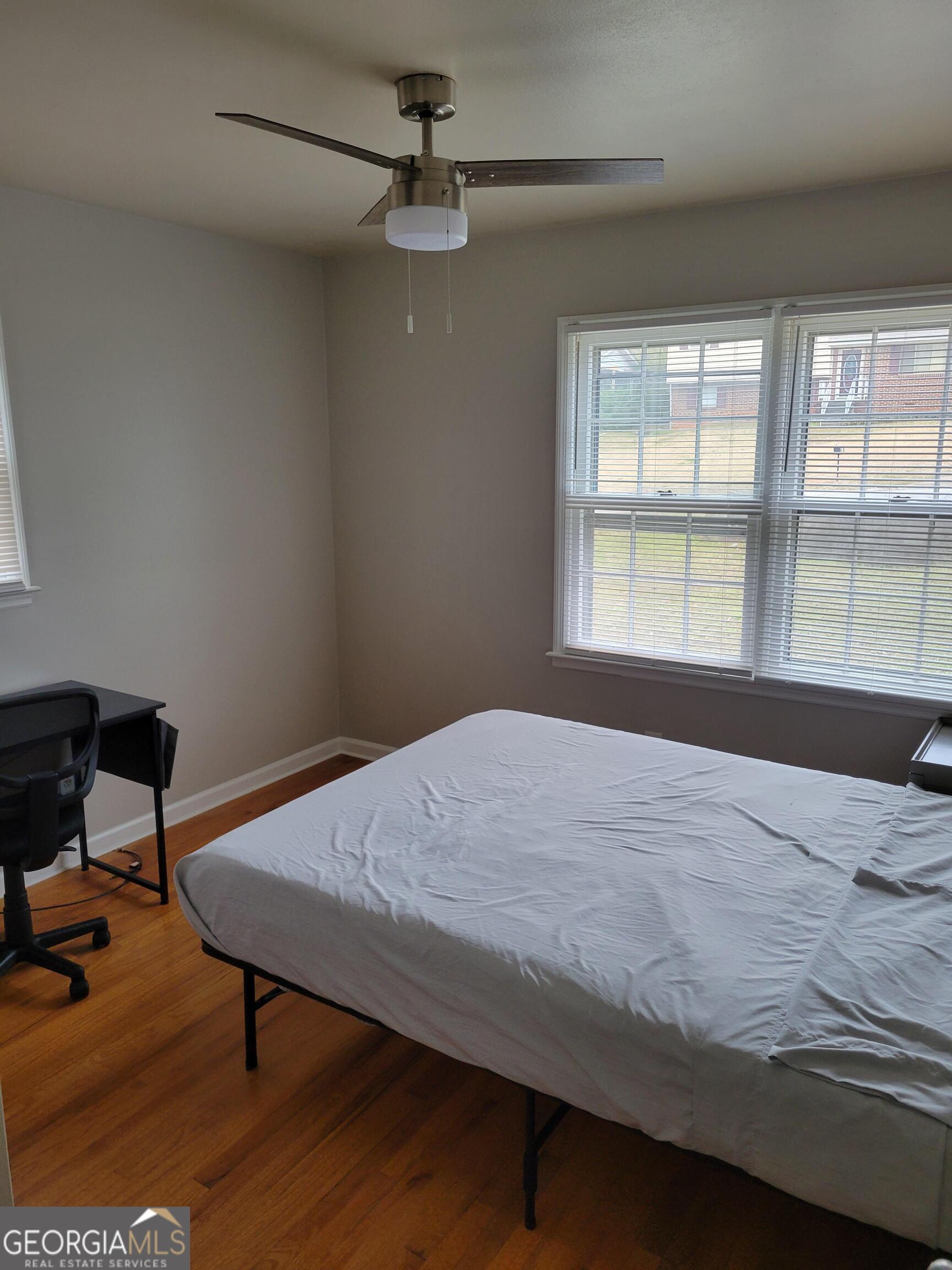 6057 Pinecreek Road Forest Park, GA 30297 - Photo 7 of 15 a bed sitting in a bedroom next to a window
