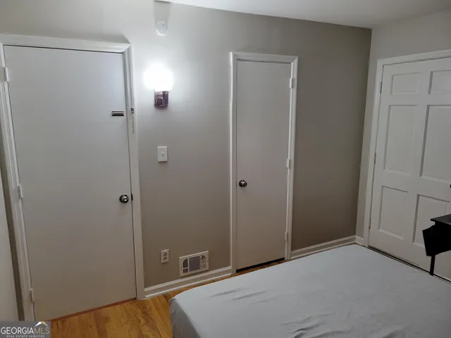 a bedroom with a bed and a view of bathroom