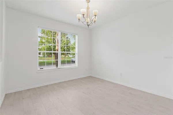 a view of a livingroom with wooden floor and staircase
