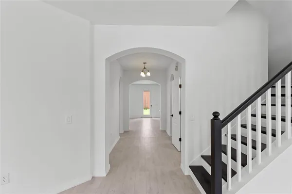 a view of a chandelier fan and entryway